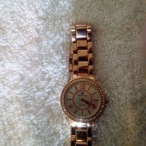 A woman's gold watch with diamonds